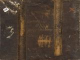 an old book with writing on it sitting on a table