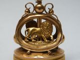 brass plated clock with a lion and a lion on it