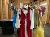 a lot of dresses hanging on a rack in a room