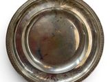 a silver plate on a white surface with a white background
