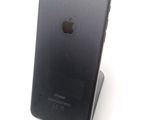 a black iphone sitting on top of a stand