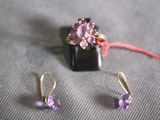 a pair of earrings and a ring sitting on a table