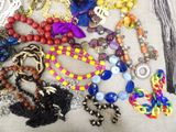 a pile of assorted necklaces and bracelets on a table