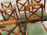 six wooden chairs with green upholstered seats