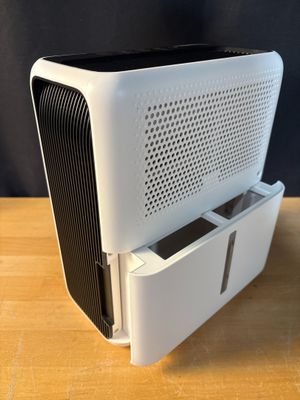 an air purifier sitting on top of a wooden table