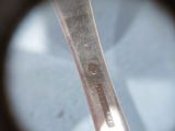 looking through a magnifying lens at a silver spoon