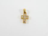 un pendentif en forme de croix en or serti de diamants sur fond blanc