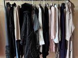 a lot of clothes hanging on a rack in a room