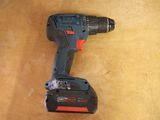 a cordless drill that is sitting on a table