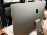 a computer monitor sitting on a desk in an office