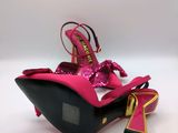 a close up of a pair of pink high heeled shoes