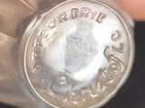 a close up of a silver bottle with a metal cap