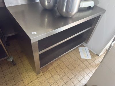 stainless steel counter top with two pots on it in a commercial kitchen