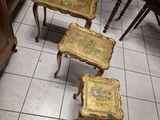 three tables that are sitting on a tiled floor