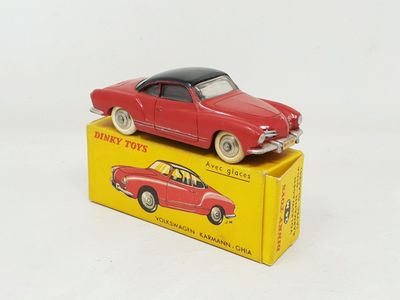 a red toy car sitting on top of a yellow box