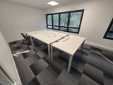 a room with two tables and two chairs in it