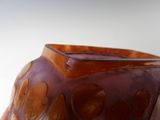 a purple vase with a brown design on it