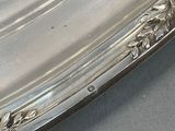 a silver plate with a flower design on it