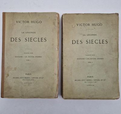 two old books sitting on top of each other on a table