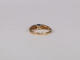 a gold ring with a sapphire stone in the middle