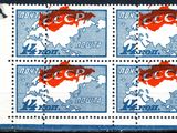 four stamps with the image of a map of the world on them