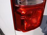 a close up of a red tail light on a white truck