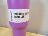 purple tumbler with a white label on it sitting on a wooden table