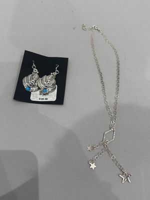 silver plated necklace with a crown and a star charm on it