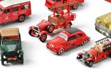 a lot of toy cars that are on a white surface