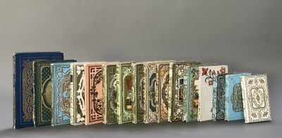 several books are lined up in a row on a gray surface