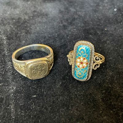 two rings are sitting on a table next to each other