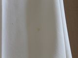 a close up of a white shirt with a stain on it
