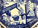 a blue and white plate with a picture of a man and a woman