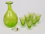 a lot of glasses and a green bottle on the table