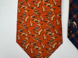 pair of orange and blue neck ties with horses and birds on them