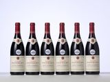 five bottles of red wine lined up in a row