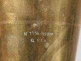 a close up of a gold vase with a name on it