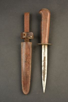 two knives are laying side by side on a black surface
