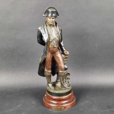 bronze statue of a man with a dog on a wooden base
