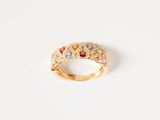 a close up of a gold ring with multi colored stones