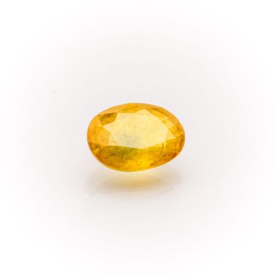 a yellow sapphire stone on a white background