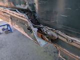 a close up of a metal door with a rusted latch