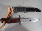 two knives that are laying next to each other on a table