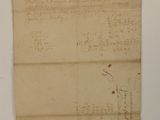 an old piece of paper with writing on it sitting on top of a table