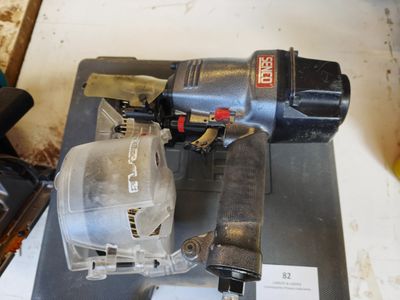 a picture of a corded nail gun on a piece of metal