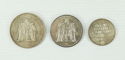 three different types of coins are shown on a white surface