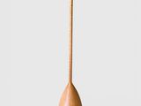 a close up of a wooden spoon on a white surface