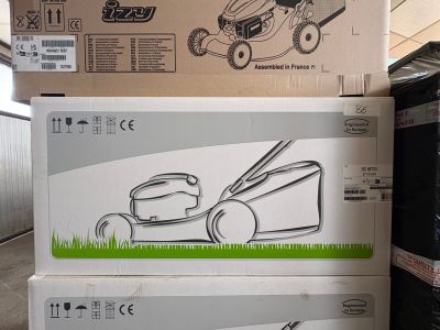 deux cartons contenant des tondeuses à gazon empilés l'un sur l'autre