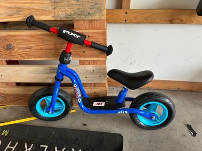 un scooter bleu posé par terre à côté d'une palette