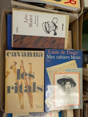 boxes of books are stacked on top of each other in a room